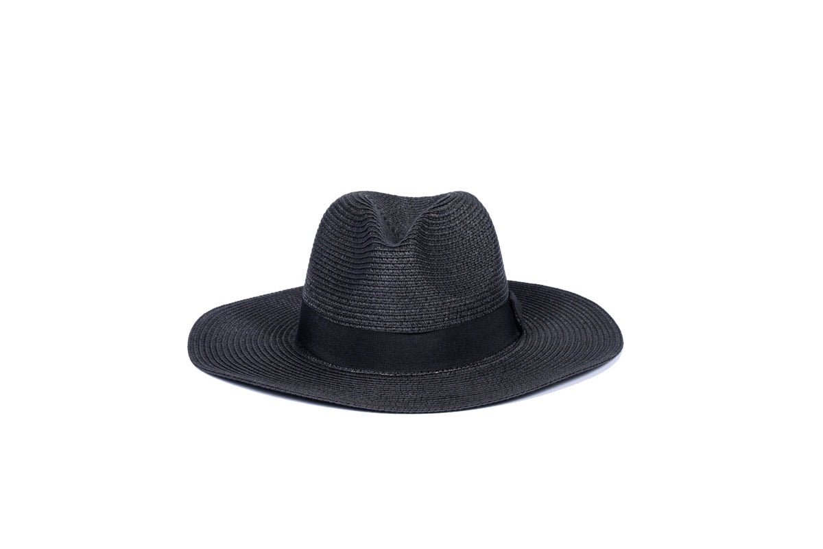 Foldable black colored hat, laid out to showcase its convenient design, perfect for stylish sun protection on the go