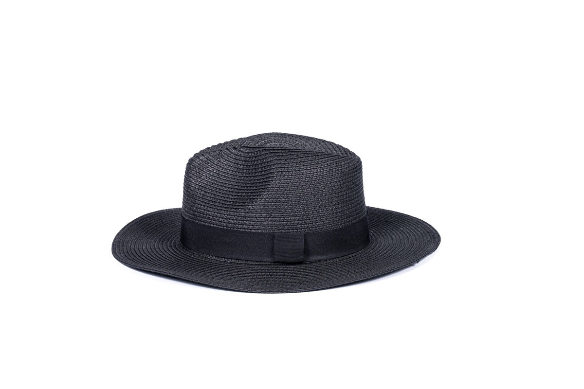 Foldable black colored hat, laid out to showcase its convenient design, perfect for stylish sun protection on the go