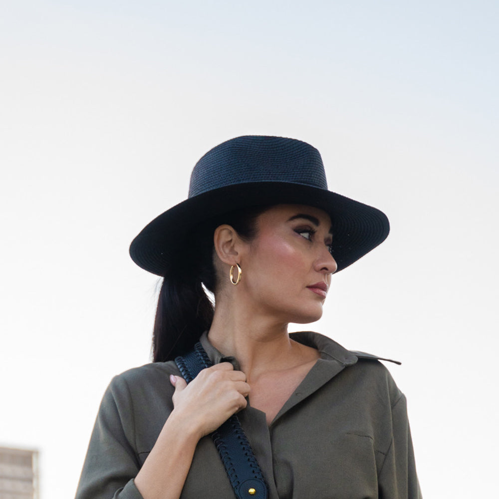 Onna Ehrlich Foldable black colored summer hat, laid out to showcase, perfect for stylish sun protection on the go and foldable for traveling 